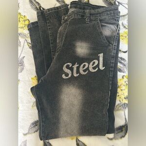 AMIRI men’s black distressed jeans with “Steel” wording in the front!